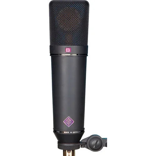 A black Neumann U87 Ai MT large-diaphragm condenser microphone with a pop filter and a transformer-balanced output connector.