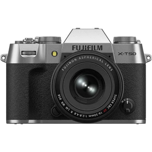 A silver FUJIFILM X-T50 mirrorless camera with an XF 16-50mm lens mounted on it.